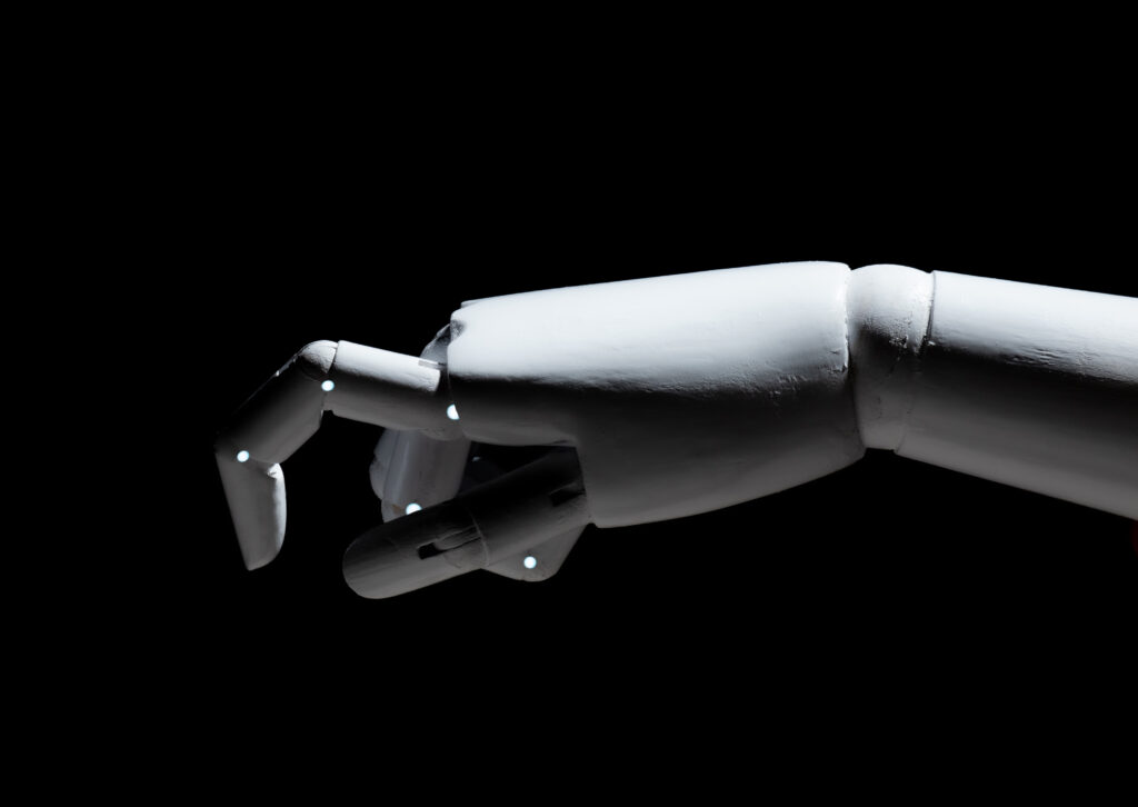 White robot hand finger point isolated on black background